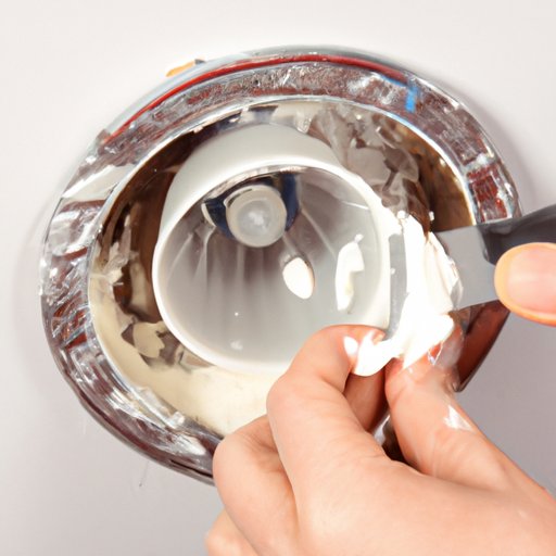 Use a Putty Knife to Carefully Leverage off the Light Bulb Cover